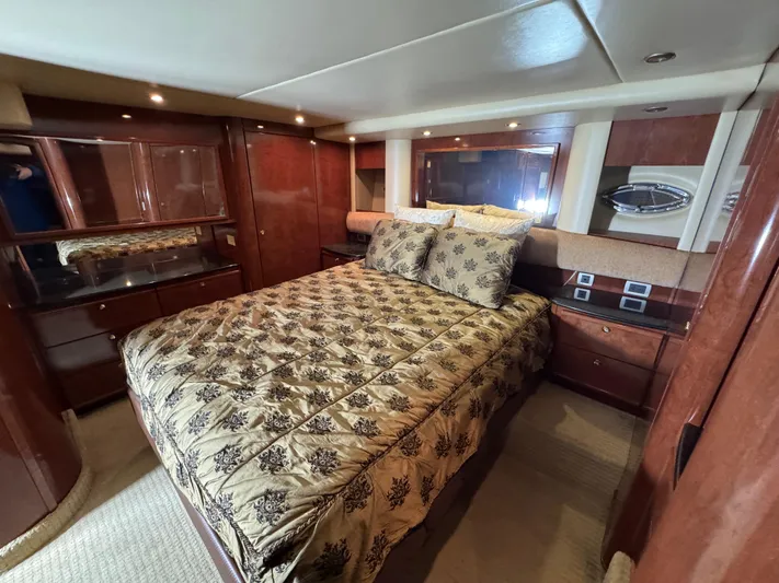  Yacht Photos Pics Luxurious bedroom interior of 2008 Meridian 580 Pilothouse yacht with elegant wood finishes.