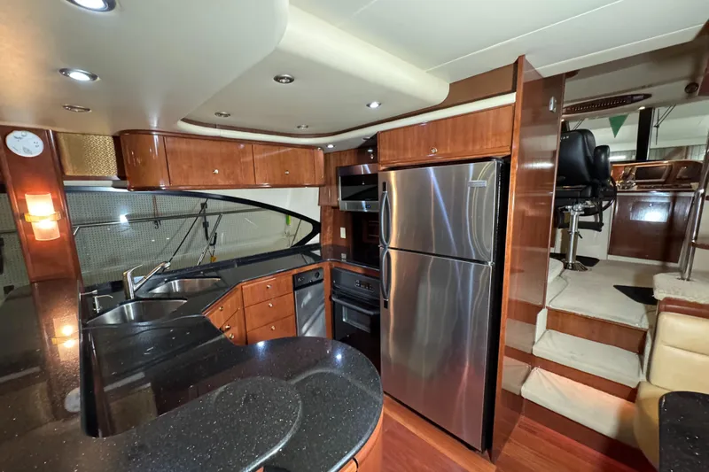  Yacht Photos Pics Luxurious 2008 Meridian 580 Pilothouse kitchen with modern appliances and elegant wood cabinetry.
