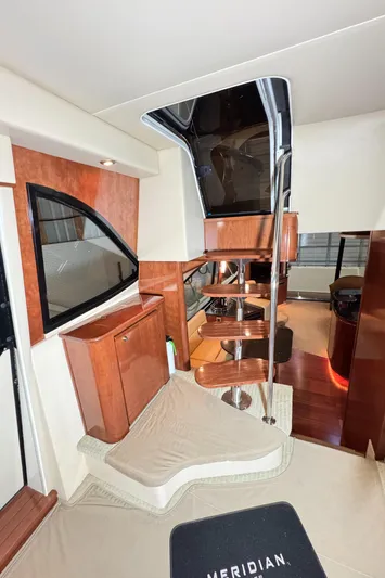  Yacht Photos Pics Interior of 2008 Meridian 580 Pilothouse with wooden stairs and modern design elements.