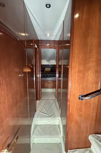  Yacht Photos Pics Interior hallway of 2008 Meridian 580 Pilothouse with wooden paneling and carpeted stairs.