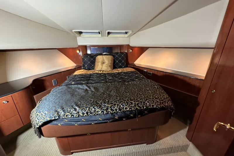  Yacht Photos Pics Luxurious bedroom in 2008 Meridian 580 Pilothouse yacht with elegant bedding and wood accents.