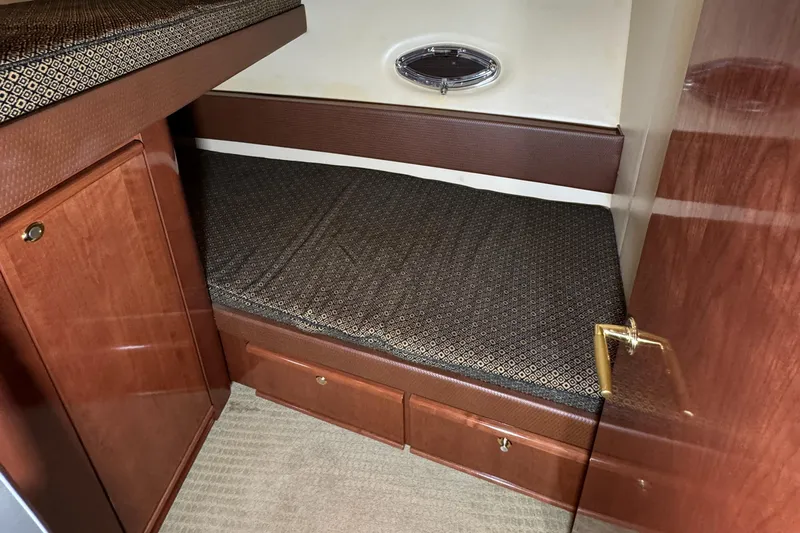  Yacht Photos Pics 2008 Meridian 580 Pilothouse cabin with wooden cabinetry and cushioned bed.