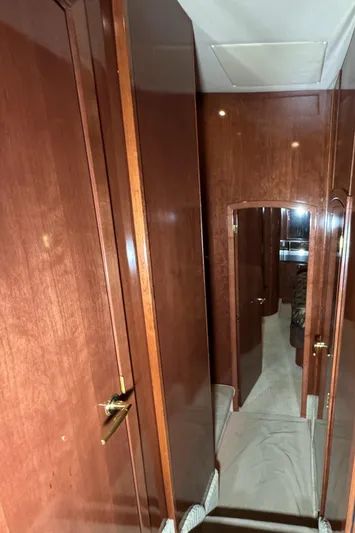  Yacht Photos Pics Interior hallway of 2008 Meridian 580 Pilothouse with wooden paneling and doors.