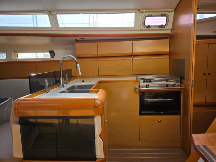  Yacht Photos Pics Interior of 2012 Jeanneau Sun Odyssey 439 yacht kitchen with modern amenities.