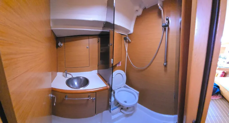  Yacht Photos Pics Interior of 2012 Jeanneau Sun Odyssey 439 yacht bathroom with sink, toilet, and shower.