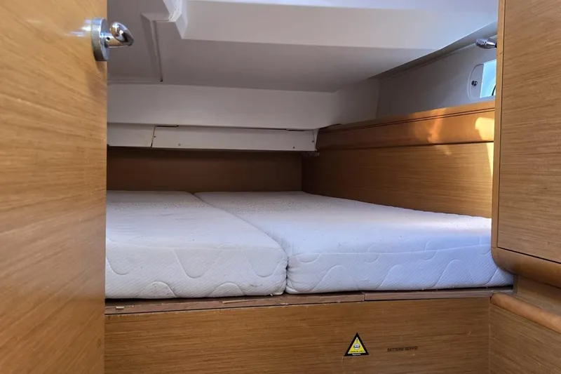  Yacht Photos Pics Cabin interior of 2012 Jeanneau Sun Odyssey 439 with twin mattresses.