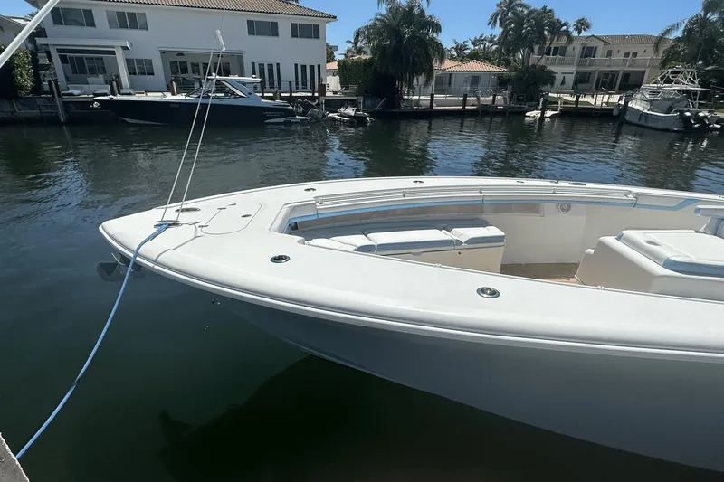  Yacht Photos Pics 2018 Yellowfin 42 boat docked in a sunny waterfront setting.