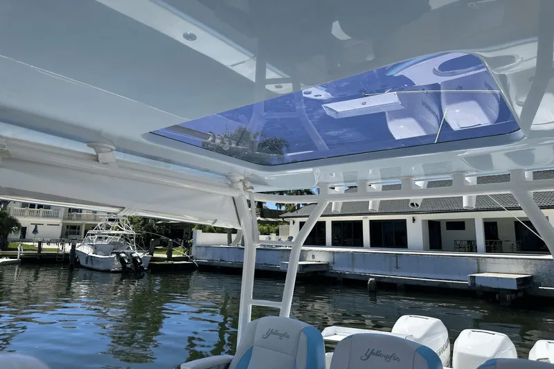  Yacht Photos Pics 2018 Yellowfin 42 boat interior with skylight, docked near waterfront homes.