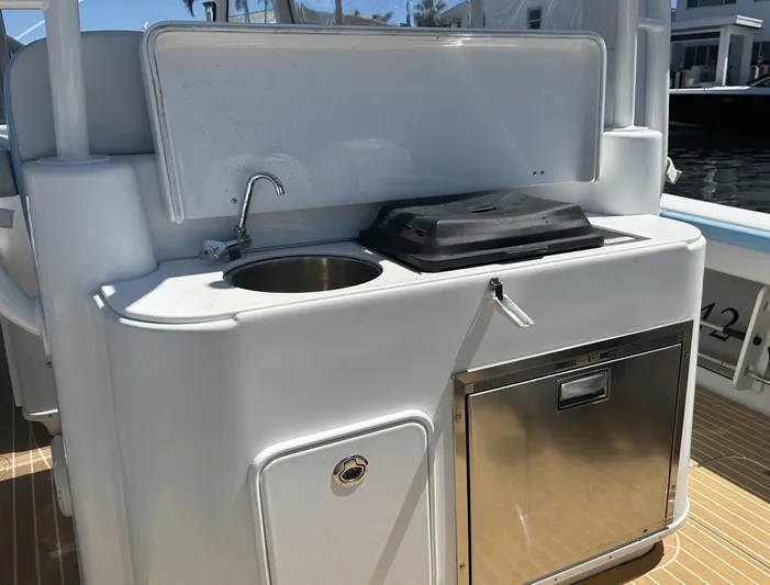  Yacht Photos Pics 2018 Yellowfin 42 boat kitchenette with sink, grill, and storage.
