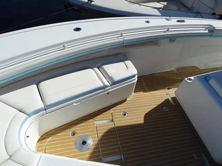  Yacht Photos Pics 2018 Yellowfin 42 boat interior with cushioned seating and teak flooring.
