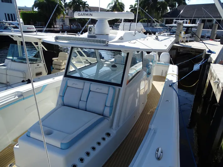  Yacht Photos Pics 2018 Yellowfin 42 boat docked, featuring Garmin equipment and spacious seating.