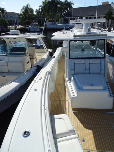  Yacht Photos Pics 2018 Yellowfin 42 boat docked, featuring spacious deck and modern design.