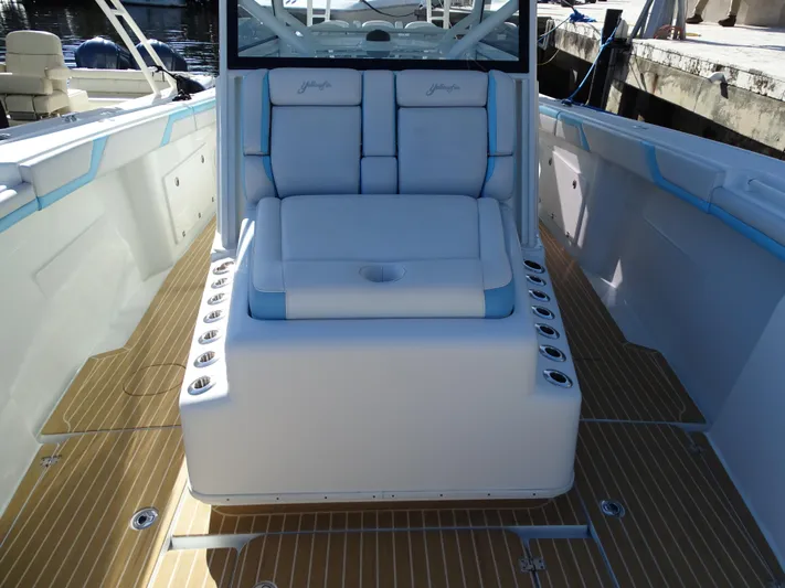  Yacht Photos Pics 2018 Yellowfin 42 boat interior with cushioned seating and rod holders.