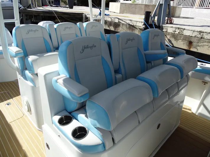  Yacht Photos Pics 2018 Yellowfin 42 boat seats with blue and white upholstery, featuring cup holders.