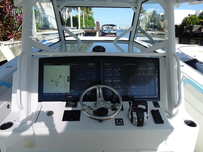  Yacht Photos Pics 2018 Yellowfin 42 boat dashboard with navigation screens and steering wheel.