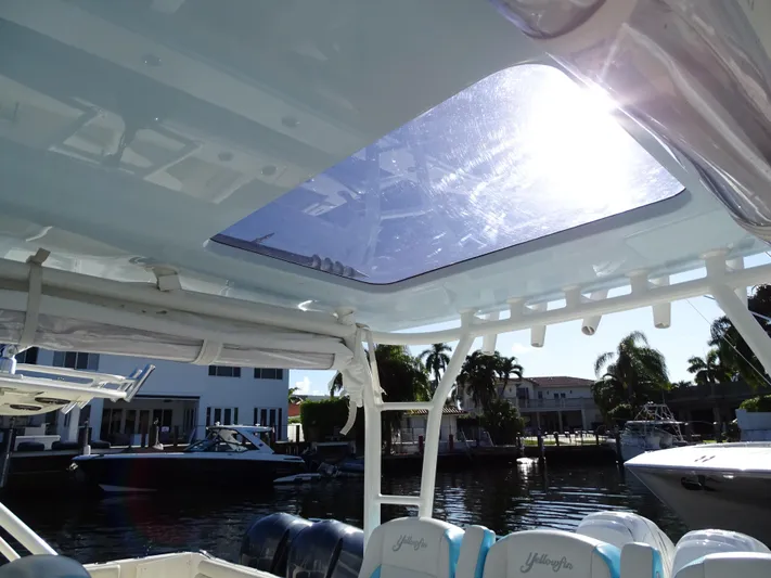  Yacht Photos Pics 2018 Yellowfin 42 boat interior with sunroof, docked near waterfront homes.