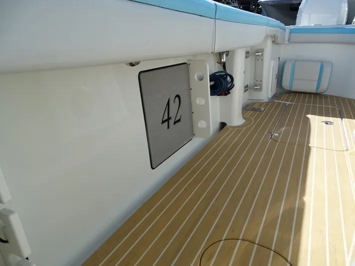  Yacht Photos Pics 2018 Yellowfin 42 boat interior with teak flooring and seating.