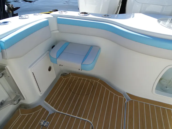  Yacht Photos Pics 2018 Yellowfin 42 boat interior with blue and white seating, wooden flooring.