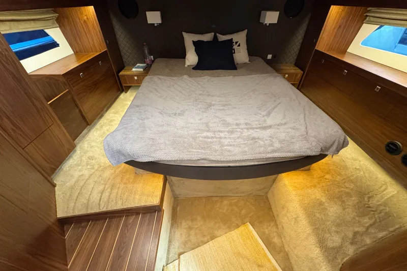  Yacht Photos Pics Luxurious cabin interior of 2023 Nord Star 49 SCY yacht with cozy bed and ambient lighting.