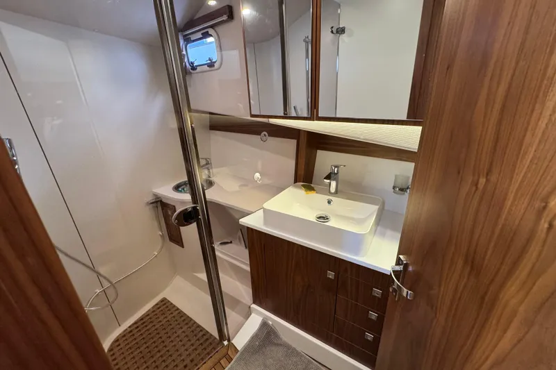  Yacht Photos Pics Luxurious bathroom in 2023 Nord Star 49 SCY yacht with modern fixtures and wood accents.