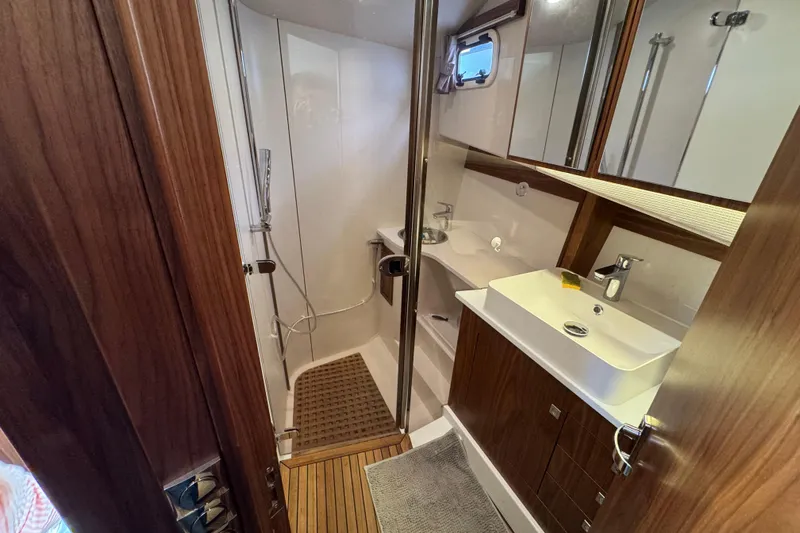  Yacht Photos Pics Luxurious bathroom in 2023 Nord Star 49 SCY yacht with modern fixtures and wooden accents.