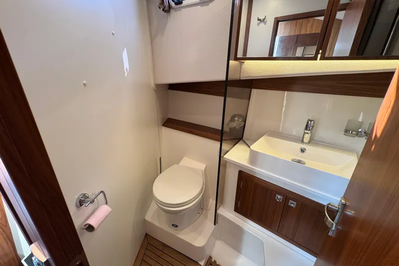  Yacht Photos Pics Modern bathroom in 2023 Nord Star 49 SCY yacht, featuring sleek design and wood accents.