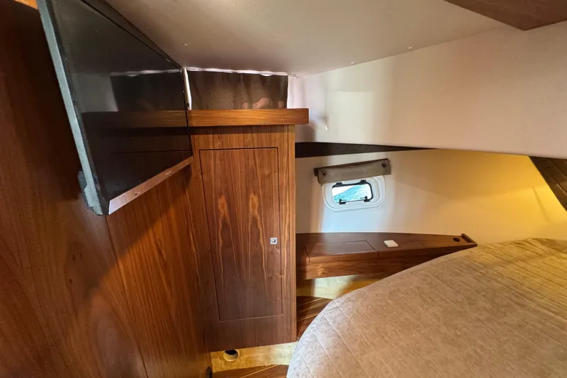  Yacht Photos Pics Luxurious cabin interior of 2023 Nord Star 49 SCY yacht with wood finish and window.