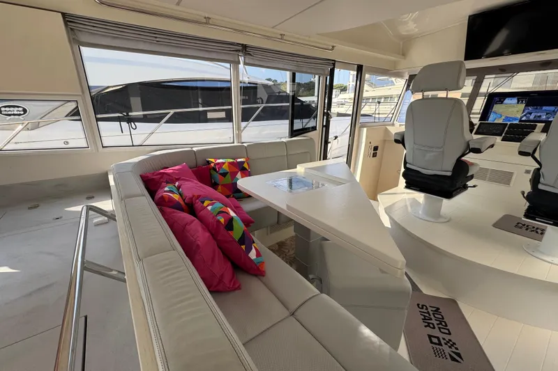  Yacht Photos Pics Luxurious interior of 2023 Nord Star 49 SCY yacht with plush seating and vibrant cushions.