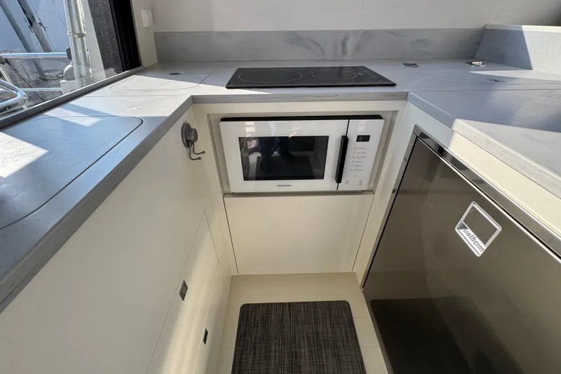 Yacht Photos Pics Modern kitchen in 2023 Nord Star 49 SCY yacht with microwave and cooktop.