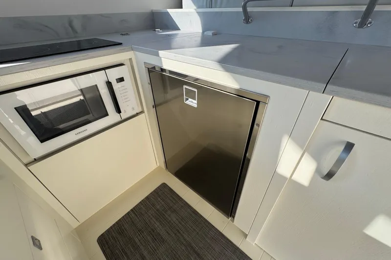 Yacht Photos Pics Modern kitchen area in 2023 Nord Star 49 SCY yacht with microwave and sleek cabinetry.