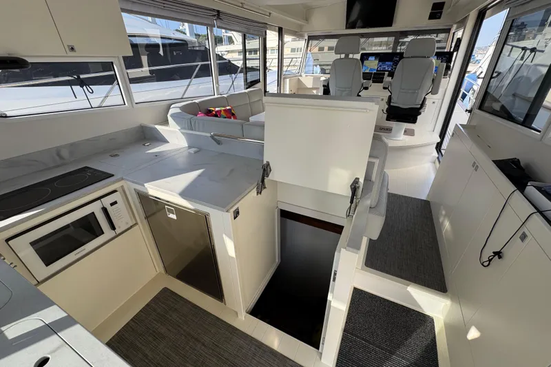  Yacht Photos Pics Modern interior of 2023 Nord Star 49 SCY yacht with kitchen and seating area.