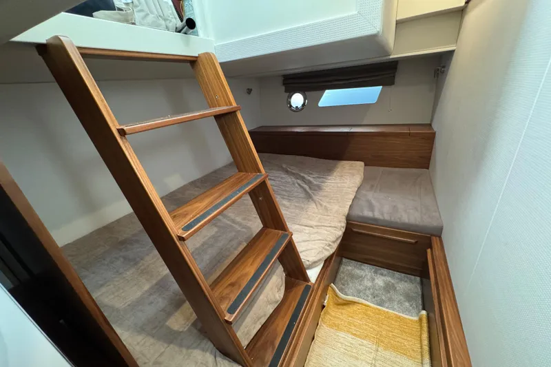  Yacht Photos Pics Cozy cabin interior of 2023 Nord Star 49 SCY with wooden ladder and bed.