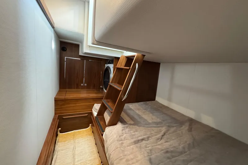  Yacht Photos Pics Interior cabin of 2023 Nord Star 49 SCY yacht with wooden ladder and cozy bedding.