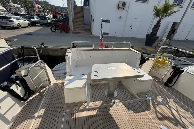  Yacht Photos Pics 2023 Nord Star 49 SCY yacht deck with seating and table, docked at marina.
