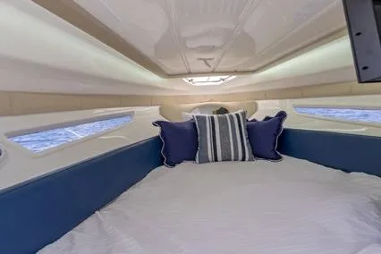  Yacht Photos Pics 2024 Hanover 305 White & Blue Edition boat interior with cozy bed and nautical decor.