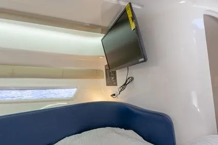  Yacht Photos Pics 2024 Hanover 305 White & Blue Edition interior with mounted TV and modern design.