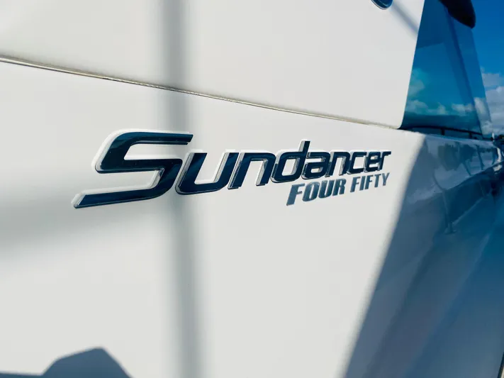 Hyde-a-way Yacht Photos Pics Close-up of 2010 Sea Ray 450 Sundancer logo on boat exterior.