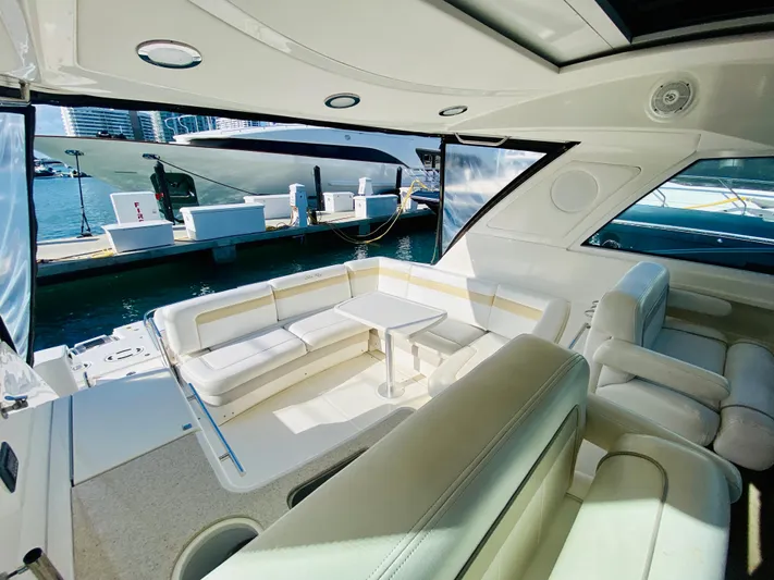 Hyde-a-way Yacht Photos Pics Luxurious interior of 2010 Sea Ray 450 Sundancer yacht with white seating and table.