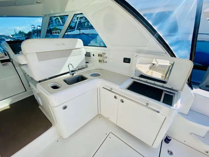 Hyde-a-way Yacht Photos Pics 2010 Sea Ray 450 Sundancer yacht interior with kitchenette and seating area.