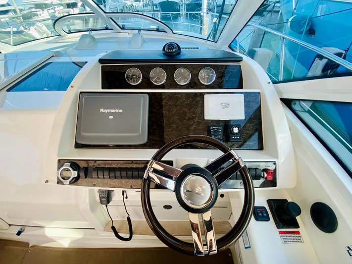 Hyde-a-way Yacht Photos Pics Helm of 2010 Sea Ray 450 Sundancer with Raymarine navigation system.