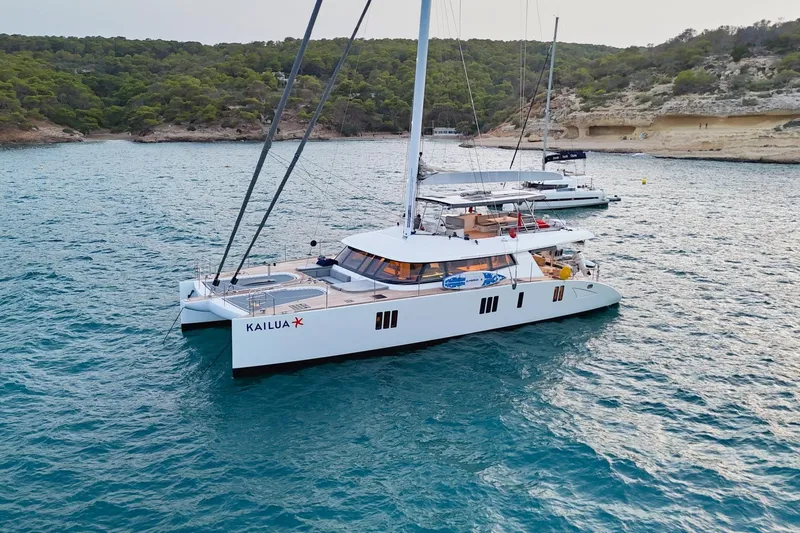 Kailua Yacht Photos Pics Luxurious 2018 Sunreef 74 catamaran anchored in scenic coastal waters.