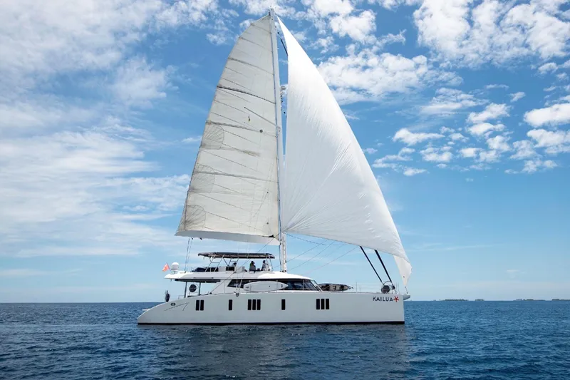 Kailua Yacht Photos Pics 2018 Sunreef 74 yacht sailing on open sea under clear blue sky.