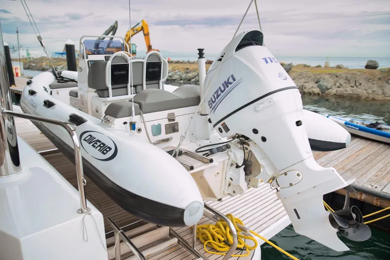 Kailua Yacht Photos Pics RIB boat with Suzuki outboard motor docked beside Sunreef 74 yacht, 2018 model.