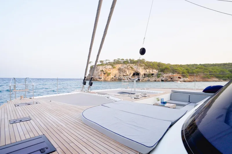 Kailua Yacht Photos Pics Luxurious Sunreef 74 yacht deck with scenic ocean and rocky coastline view, 2018 model.