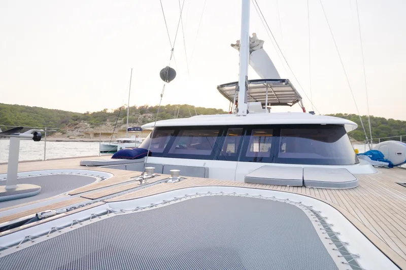 Kailua Yacht Photos Pics Luxurious 2018 Sunreef 74 yacht deck with scenic coastal backdrop.