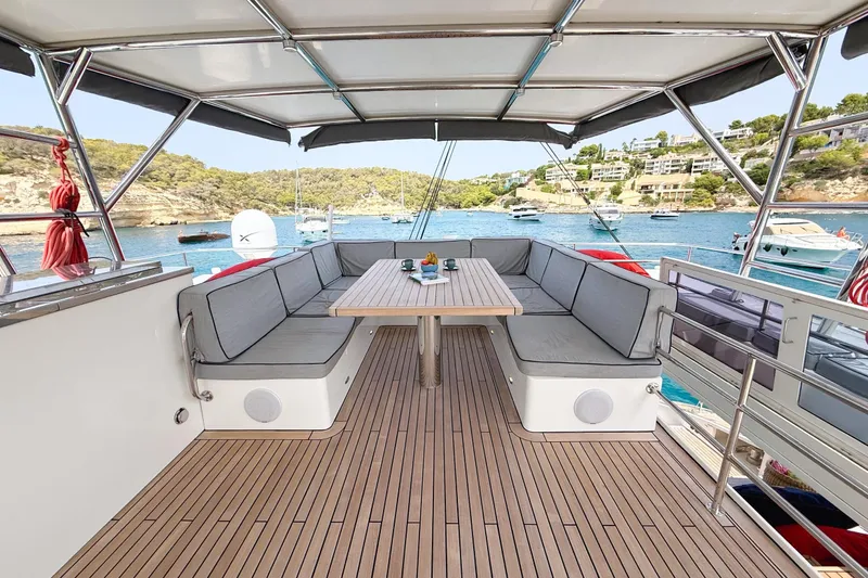 Kailua Yacht Photos Pics Luxurious Sunreef 74 yacht deck with seating, table, and scenic ocean view, 2018 model.