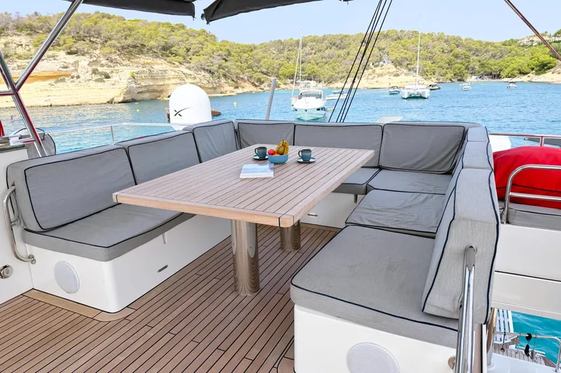 Kailua Yacht Photos Pics Luxurious Sunreef 74 yacht deck with seating, table, and scenic ocean view, 2018 model.