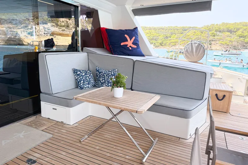 Kailua Yacht Photos Pics Luxurious Sunreef 74 yacht deck with cozy seating, table, and scenic ocean view.