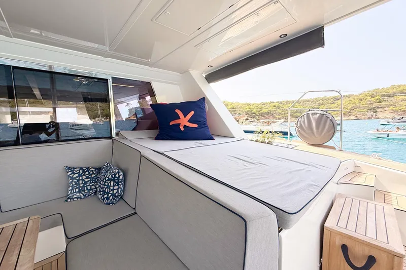 Kailua Yacht Photos Pics Luxurious Sunreef 74 yacht interior with comfortable seating, cushions, and scenic ocean view.