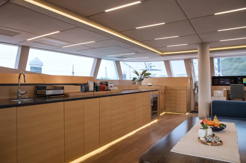 Kailua Yacht Photos Pics Luxurious interior of 2018 Sunreef 74 yacht with modern kitchen and dining area.